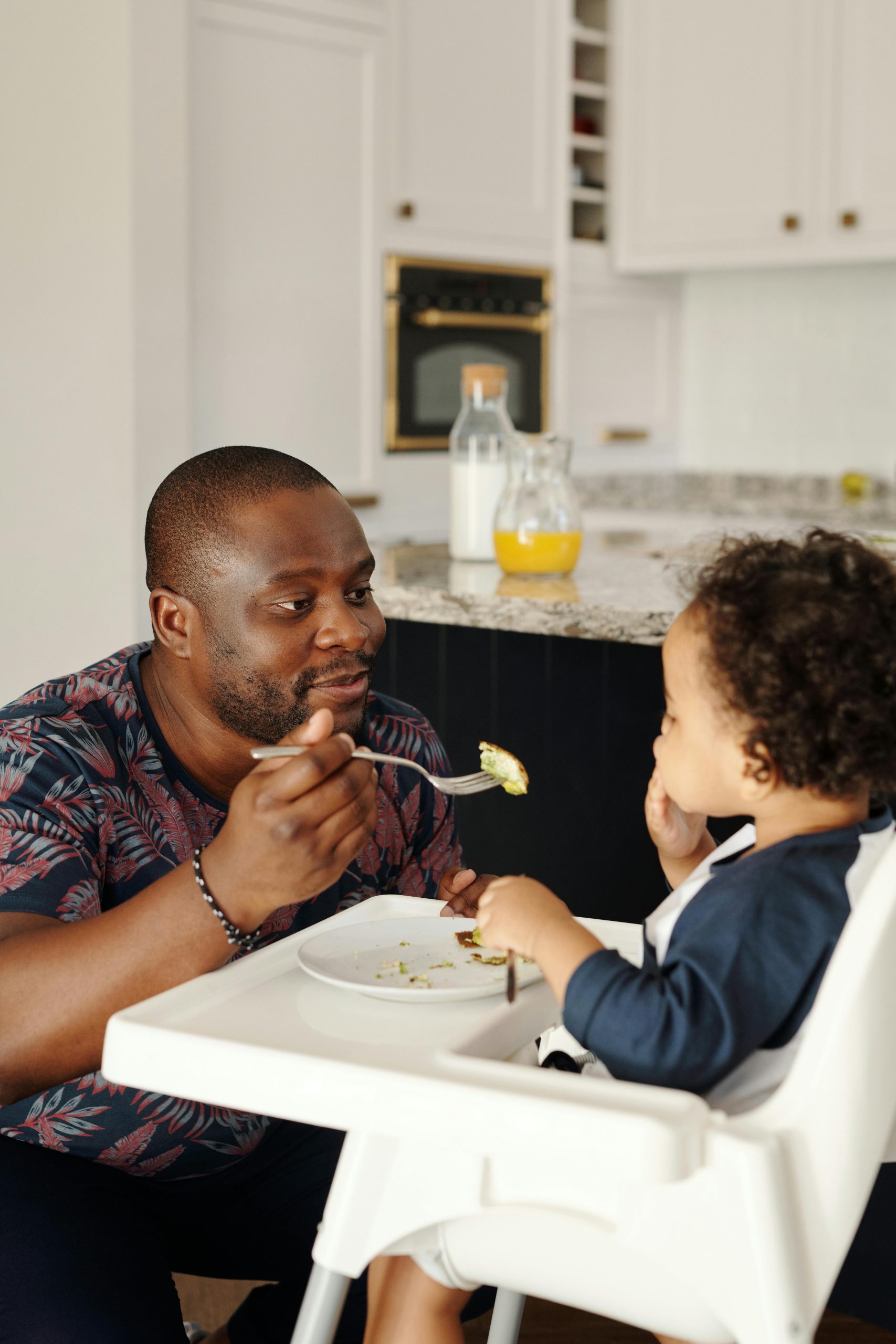 dad feeding toddler